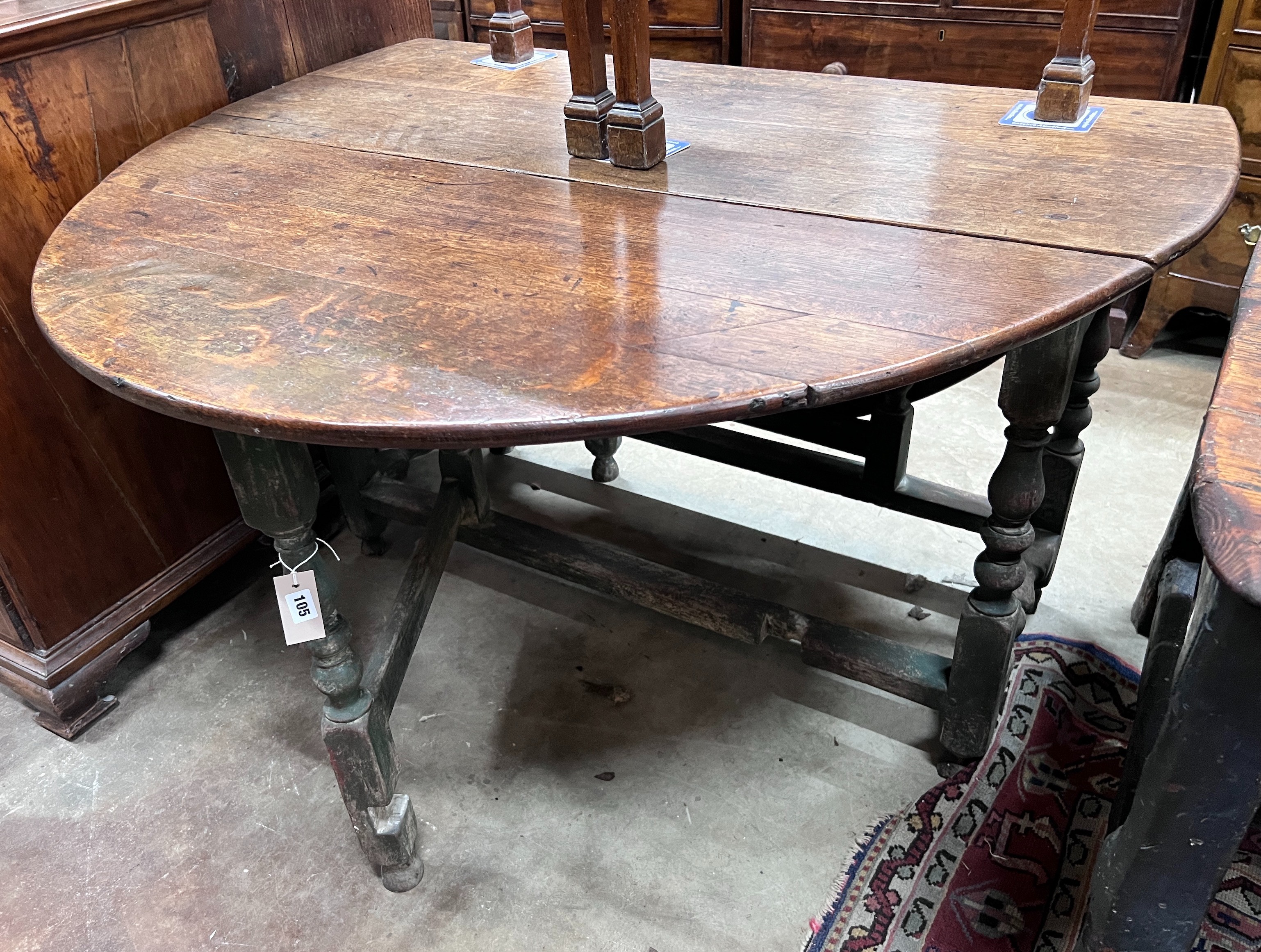 An 18th century oak gateleg dining table, the turned underframe with traces of old paint, length 123cm, depth extended 134cm, height 72cm *Please note the sale commences at 9am.